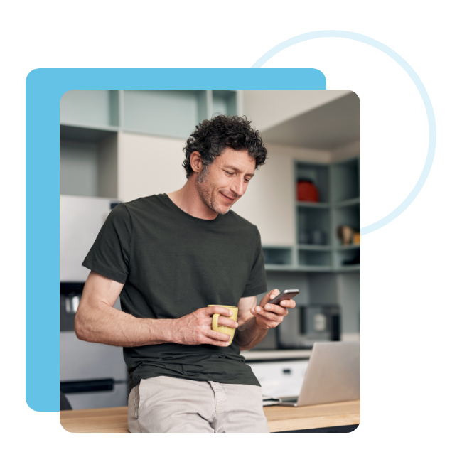 man drinking coffee looking at smart phone
