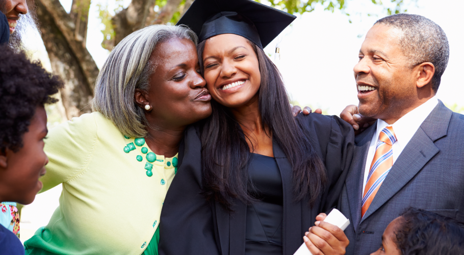 A mom and dad celebrating their recent graduate daughter