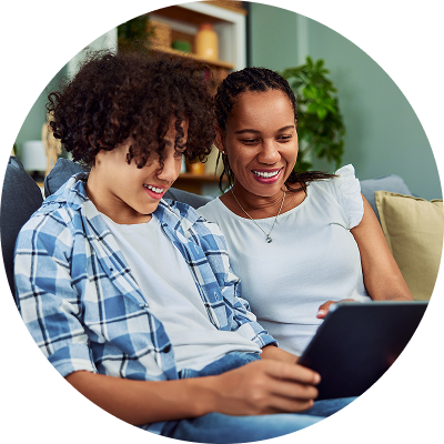 Parent with her teen son looking at credit cards online.