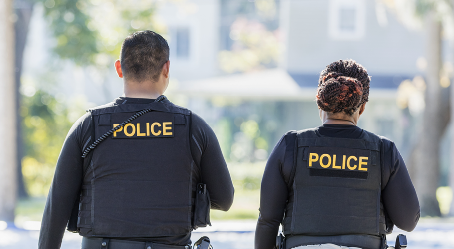 on male and one female police officers walking