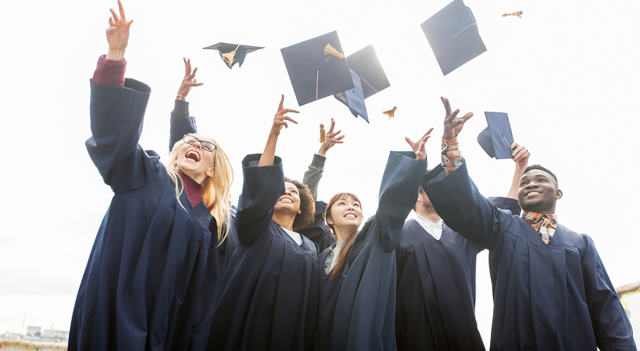 a group of graduates throwing their graduation caps in the air