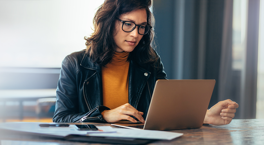 a woman in yellow looking at a computer
