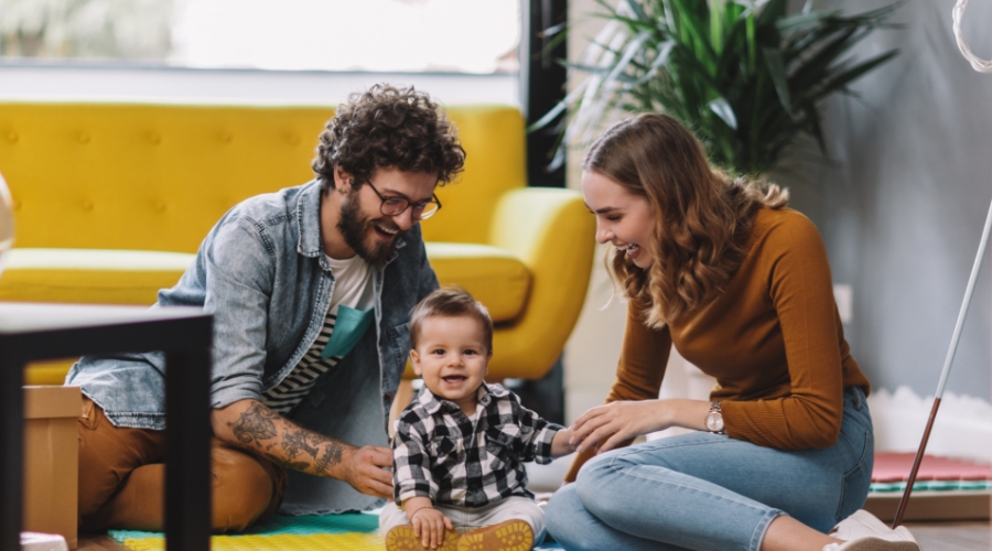 Young family playing in the living room.