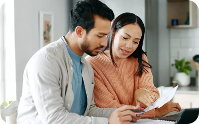 Couple looking over their billing statements.