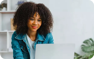 Smiling woman on her laptop.
