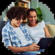 Parent with her teen son looking at credit cards online.