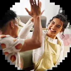 Couple high fives after making plan to payoff bad debt. 