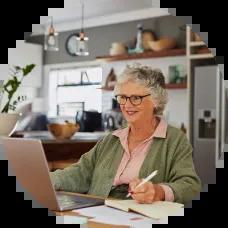Older woman looking at her savings bonds online. 