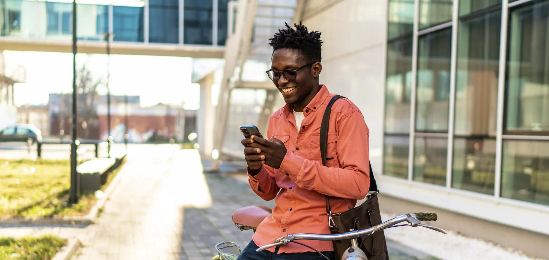 Man taking a break from riding his bike and checking on his Civic accounts.