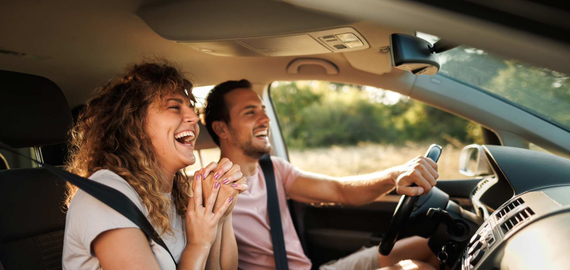 A happy couple enjoying their road trip in their new car, all thanks to Civic's auto loan and GAP coverage.
