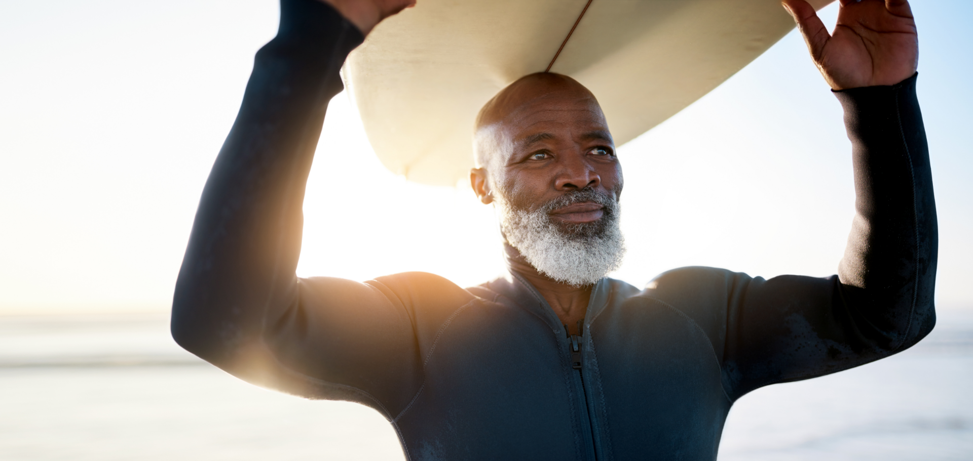 Senior man happily enjoying his retirement by surfing, thanks to his IRA retirement account with Civic.