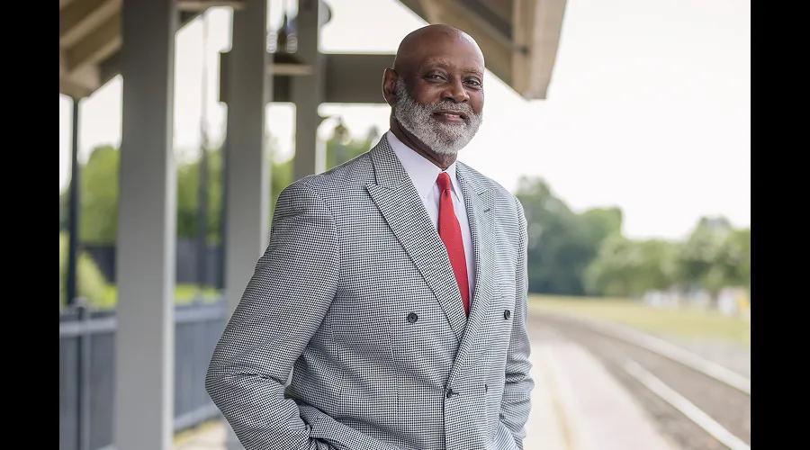 Civic's chairman of the board Dr. Aaron Noble standing next to trains tracks in Burlington, NC.