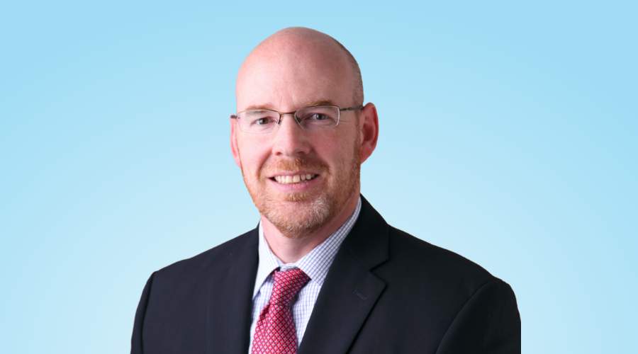 Chris Madsen on a blue background.