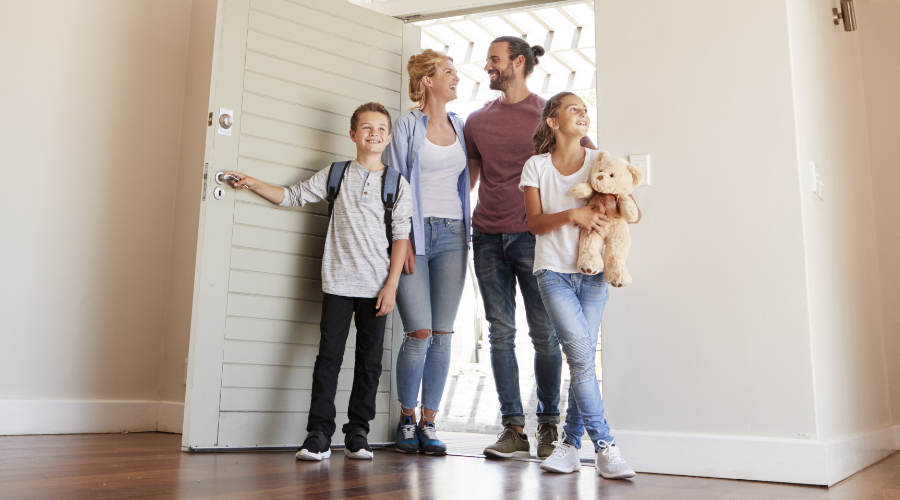 Family walking into their newly purchased home.