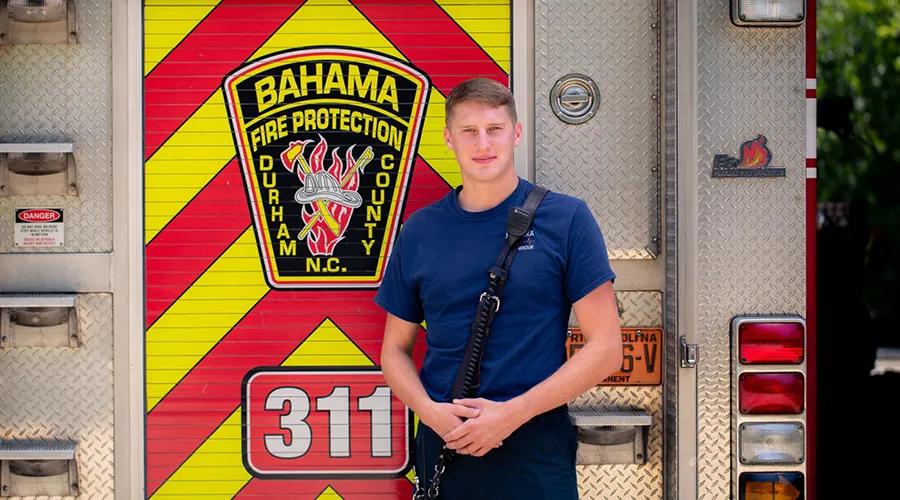 Bahama firefighter posing in front of a fire truck.