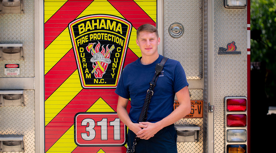 Bahama firefighter posing in front of a fire truck.