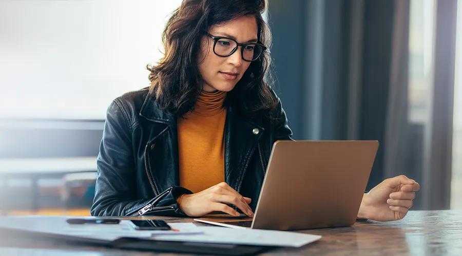 a woman in yellow looking at a computer