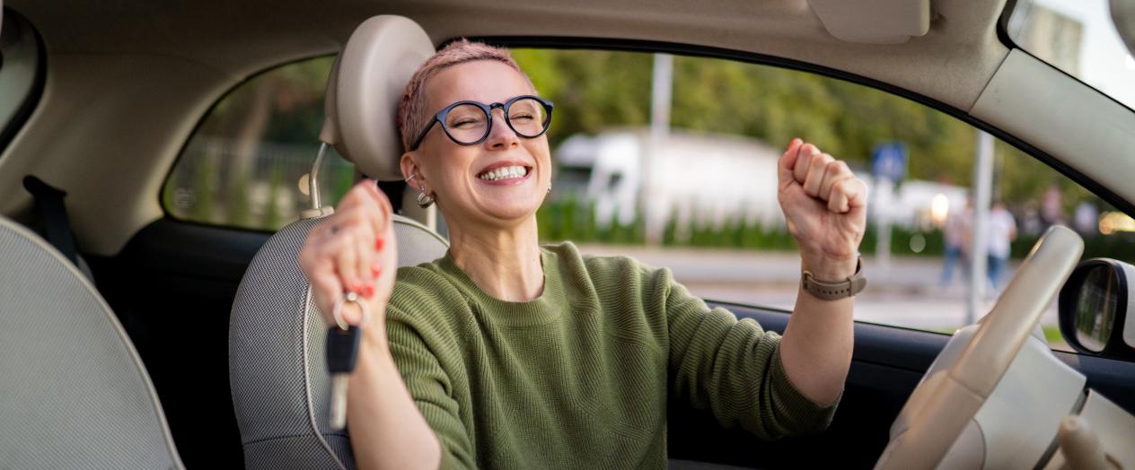 Smiling woman thrilled about her new car made possible by Civic’s low auto loan rate