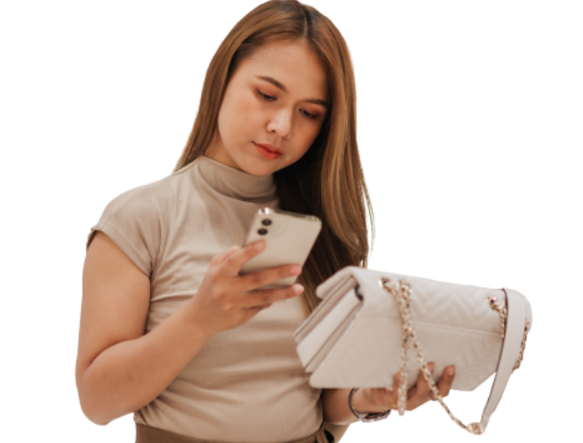 Woman comparing prices while shopping for a handbag. 