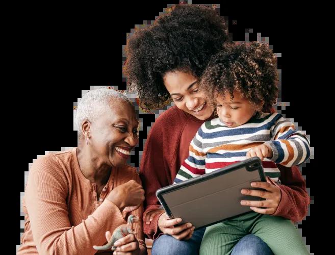 A mother sits with her son on her lap, sharing the Civic NCUA Share Insurance coverage page on a tablet with the grandmother.