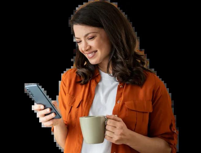 A woman enjoying her morning cup of coffee while easily and conveniently transferring funds using the Civic mobile app.