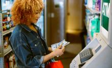 Woman getting cash out of an ATM
