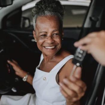 A woman uses her Civic new auto loan to purchase a new car.