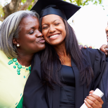 A mom and dad celebrating their recent graduate daughter