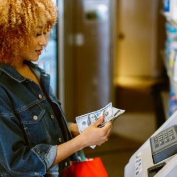 Woman getting cash out of an ATM