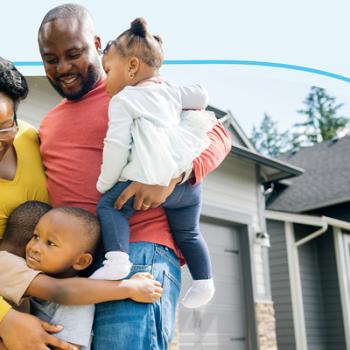 A family standing and celebration there first home. 