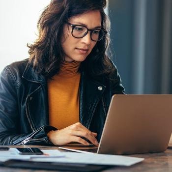 woman on her laptop doing her online banking.