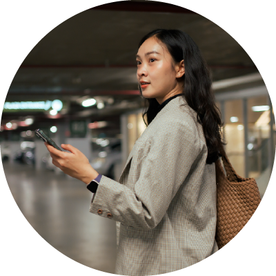 Woman in a airport parking garage looking for her car. 
