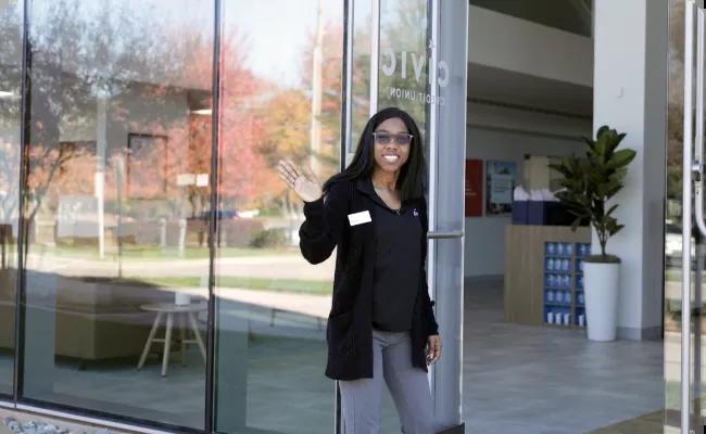 Civic branch employee holding the door and welcoming our members.