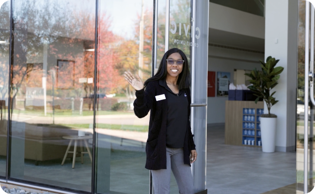 Civic branch employee holding the door and welcoming our members.
