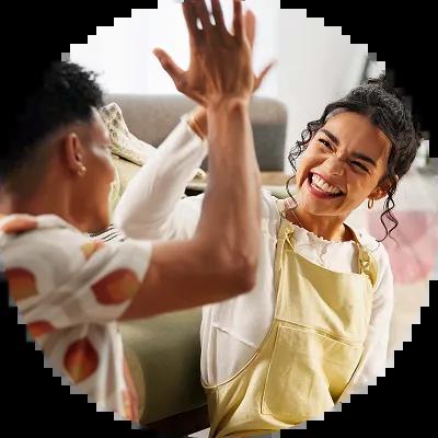Couple high fives after making plan to payoff bad debt. 