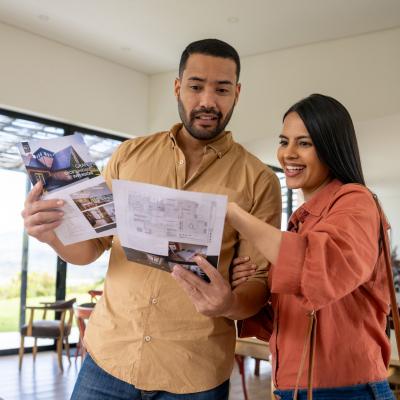 Couple looking over housing floor plans for a new Home