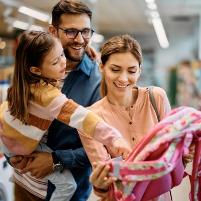 Family purchasing a bookback for there Childs first year in school.