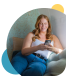 Woman on her phone, checking the Civic app in the comfort of her own home. 