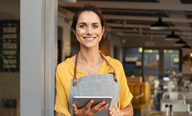 Young woman small business owner utilizing the digital tools Civic provides to manage her business money. 