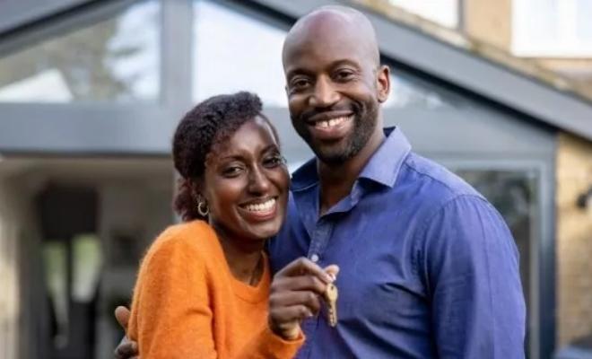 Couple standing in front of their new home thanks to Civic Credit Union's first-time homeowners loan.