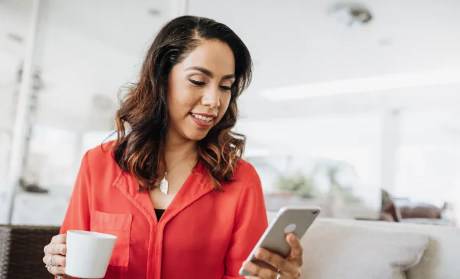 Woman checking her Money Market dividends on the Civic Credit Union mobile app. 