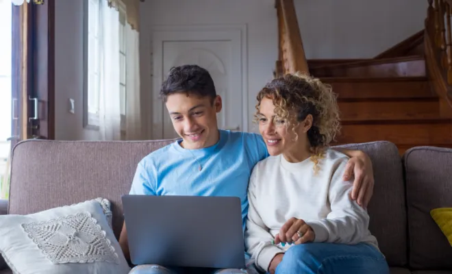Teenager checking on his NextGen Savings Account with his mother. 