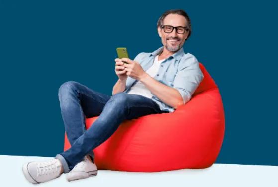 Man sitting on red beanbag chair, applying for Civic's 17 month promotional Choice Certificate.