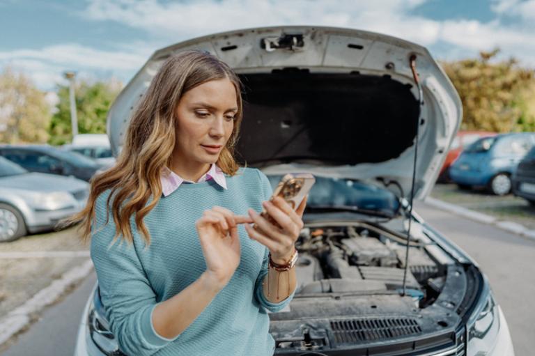 Woman using the Route 66 app to find an auto repair shop.