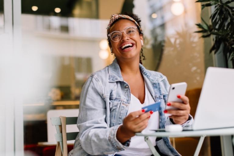 Woman happy and smiling after seeing her rewards balance for her Civic Rewards Card.