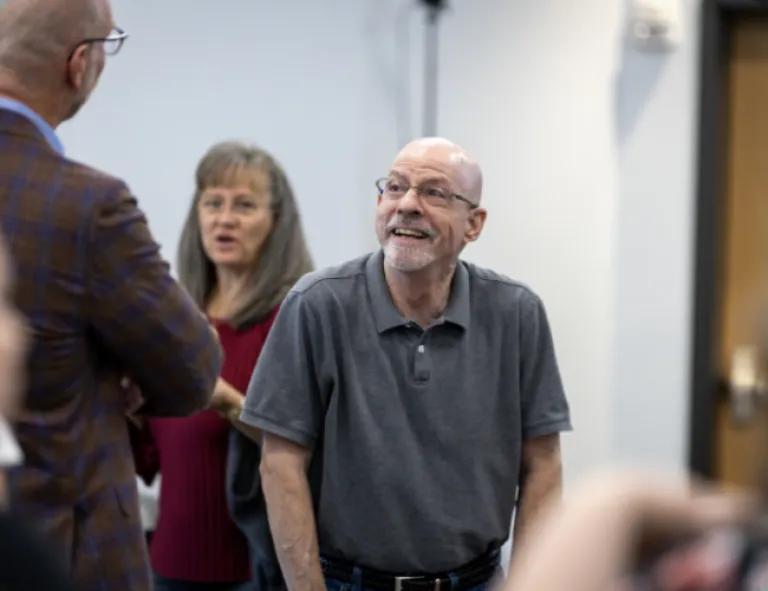 two men chatting at a meeting