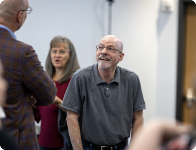 two men chatting at a meeting