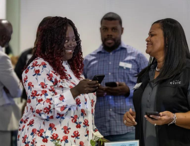 two women chatting at a Civic meeting