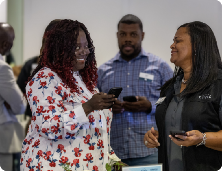 two women chatting at a Civic meeting