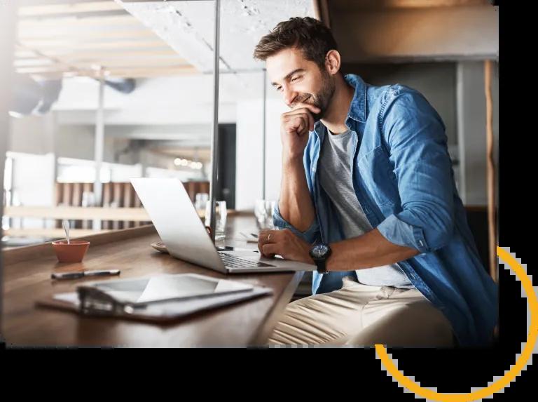 man sitting at a coffee shop on his computer.